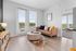 furnished living area in apartment with sofa and table