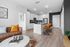 furnished living and kitchen with island in apartment