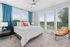furnished bedroom with large window and bed