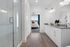 furnished bathroom with sink and shower, peeking into bedroom with bed