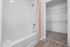furnished bathroom with tub shower and closet in apartment