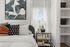 Furnished bedroom with bed and sidetables