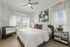 Furnished bedroom with bed and sidetables