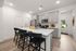 Furnished kitchen with large island and grey cabinets