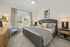 Furnished bedroom with large bed and dresser