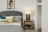 Furnished bedroom with large bed and dresser