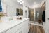 Primary bathroom with double vanity and large walk-in shower