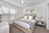 Furnished primary bedroom with large bed