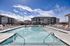 Swimming pool with apartments behind on a sunny day
