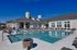 Swimming pool with clubhouse behind on a sunny day