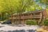 Charming brick apartment building with lush greenery and convenient parking.