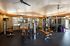 Spacious fitness center equipped with modern workout machines and ample natural lighting.