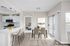 Chic apartment interior with open kitchen, stylish dining area, and cozy bedroom view.