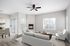 Sophisticated living room with a modern fireplace, large windows, comfortable seating, and open dining area.