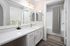 Bright and modern bathroom featuring a marble countertop, stylish vanity, and chic lighting.