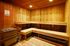 Warm and inviting wooden sauna room with bench seating and ambient lighting.