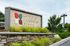 Elegant entrance sign for Timberline Place surrounded by lush greenery and landscaped stonework.