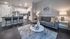 Stylish open-concept living room with modern kitchen, featuring contemporary furniture and elegant decor.