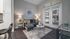 Sleek living room with modern gray furniture, stylish decor, and large windows overlooking a pool.