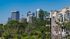 Panoramic view of modern high-rise buildings and lush green surroundings.