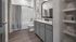 Sleek modern bathroom featuring granite countertops, elegant cabinetry, and a relaxing bathtub.
