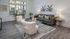 Inviting modern living room with chic furniture, large windows, and elegant decor.
