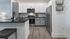 Sleek contemporary kitchen with stainless steel appliances, subway tile backsplash, and elegant cabinetry.