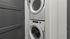 Stacked washer and dryer in a compact laundry area with modern design.