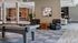 Elegant apartment lounge with a billiards table, leather seating, and stylish decor.