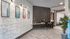 Elegant apartment interior featuring a modern workspace with dual chairs, framed city artworks, and stylish decor.