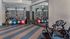 Modern fitness center featuring exercise bikes, medicine balls, and a mirrored wall.