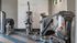 Modern fitness center with various high-end exercise machines.