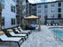 Inviting outdoor pool area with lounge chairs and cabana in an upscale apartment complex.
