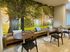 Inviting lounge area with elegant furniture and a vibrant forest-themed mural.
