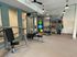 Modern apartment gym with exercise equipment, colorful stability balls, and medicine balls.