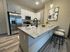Sleek modern kitchen with stainless steel appliances, granite countertop, and stylish pendant lighting.