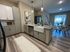 Bright and inviting open-concept kitchen and living area with modern furnishings and natural light.