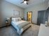 Cozy bedroom with a stylish bed, soft lighting, and a modern ensuite bathroom.