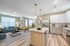 Spacious modern kitchen and living room with stylish decor and natural light.