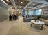 Elegant communal space featuring a plush gray sofa, large windows, and stylish decor.