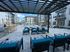 Elegant outdoor seating area overlooking a stunning pool surrounded by modern apartment buildings.