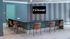 Chic office lounge featuring a sleek meeting table and contemporary chairs in a serene blue setting.