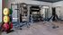 State-of-the-art gym in an upscale apartment complex with weights and exercise equipment.