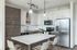 Modern kitchen with sleek cabinetry, stainless steel appliances, and a central island with stylish lighting.