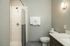 Sleek bathroom with modern shower, elegant lighting, and stylish vanity.