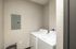 Compact laundry space with modern washer and dryer set against a neutral wall.
