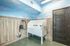 Bright and stylish pet grooming station with a sky-themed wall and modern fixtures.