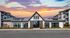 Charming modern apartment facade at The Watts with a stunning sunset background.