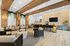 Sophisticated lounge area with modern seating, wooden accents, and stylish pendant lighting.