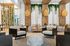 Chic lounge area featuring rustic wooden elements, modern seating, and lush greenery.